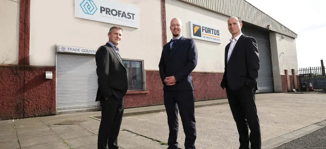 Three members of the Profast Group team standing in front of the Belfast offices and warehouse