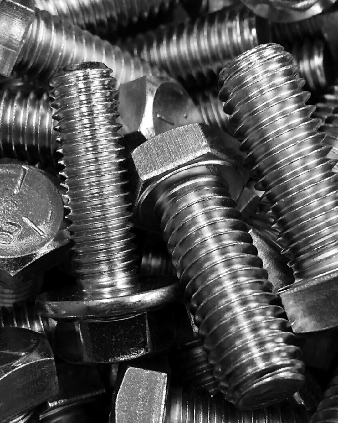 A pile of silver fasteners 