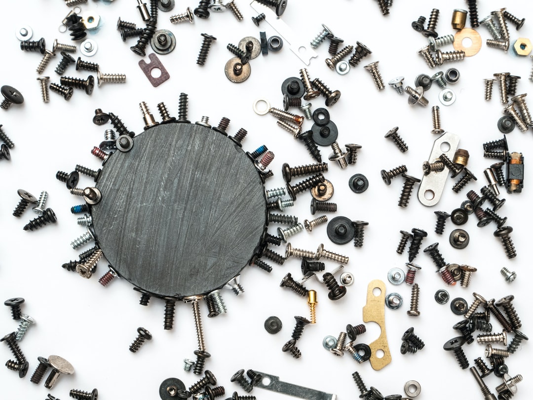 A magnet that has attracted multiple different nuts and bolts